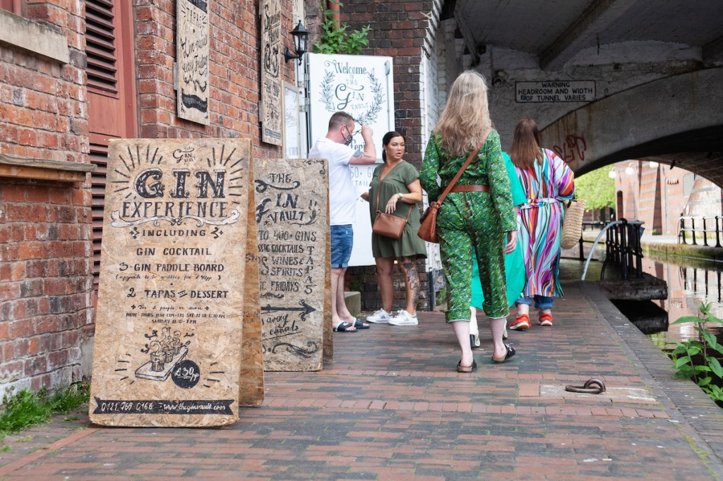 Three crones walking on towpath. A woman is looking in shock.